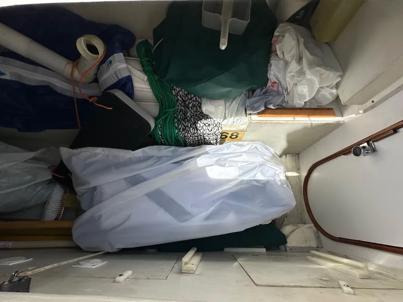 Slide: The Image of Storage compartment of a 1996 J Boats J/120, filled with sailing gear and equipment. - 33