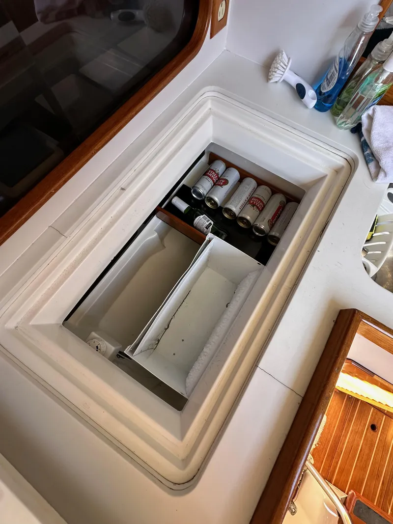 Slide: The Image of Storage compartment on a 1996 J Boats J/120 yacht with organized items. - 41