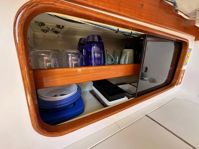 Slide: The Image of Cabinet interior of 1996 J Boats J/120 yacht with glassware and kitchen items. - 42