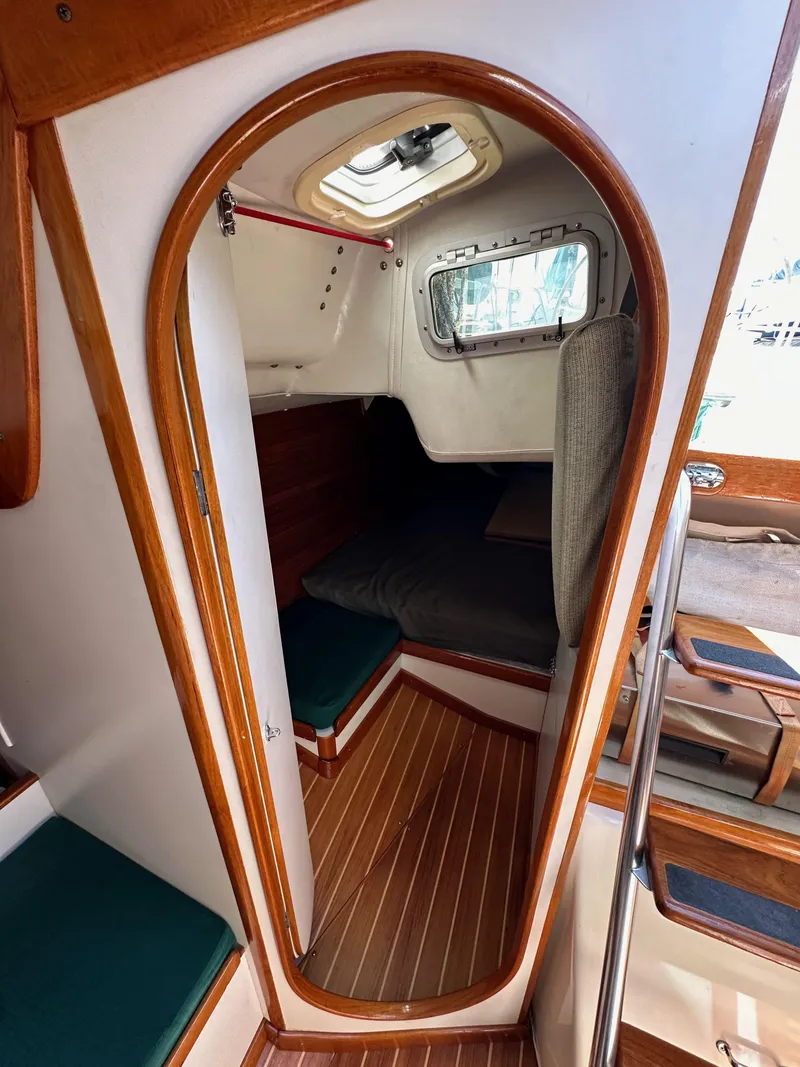 Slide: The Image of 1996 J Boats J/120 cabin interior with wood trim and cozy seating area. - 45