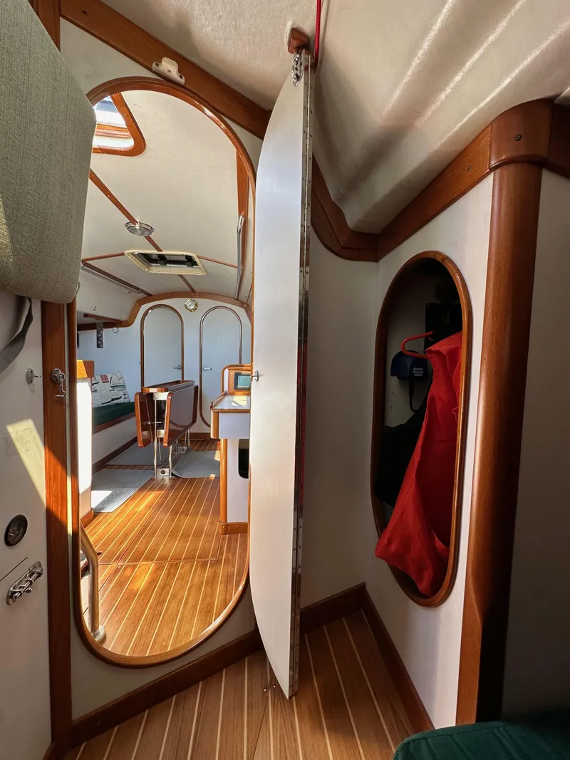 Slide: The Image of Interior of 1996 J Boats J/120 sailboat with wooden flooring and elegant design. - 49