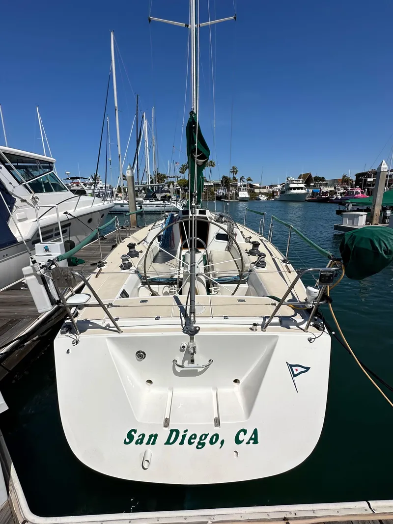 Slide: The Image of 1996 J Boats J/120 docked in San Diego marina under clear blue sky. - 5