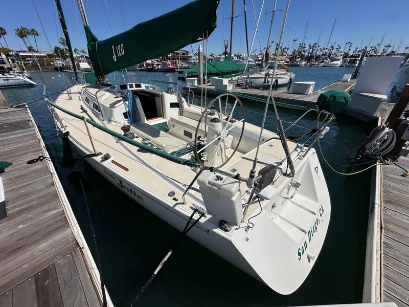 Slide: The Image of 1996 J Boats J/120 sailboat docked in marina, featuring sleek design and spacious deck. - 6