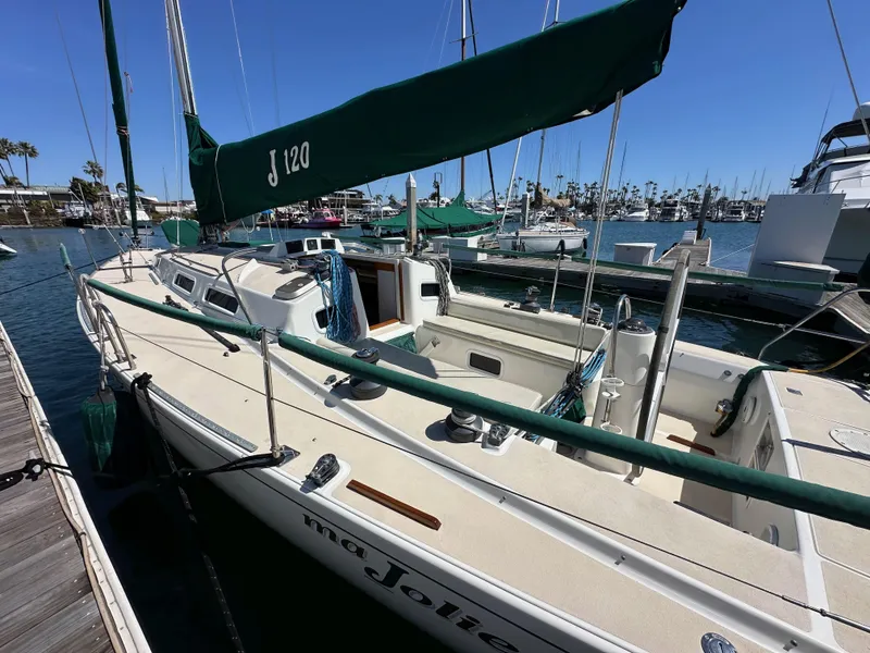 Slide: The Image of 1996 J Boats J/120 sailboat docked in marina under clear blue sky. - 7