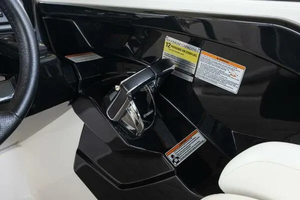 Slide: The Image of 2016 Yamaha Boats 242 Limited S E-Series throttle control and dashboard with safety labels. - 23