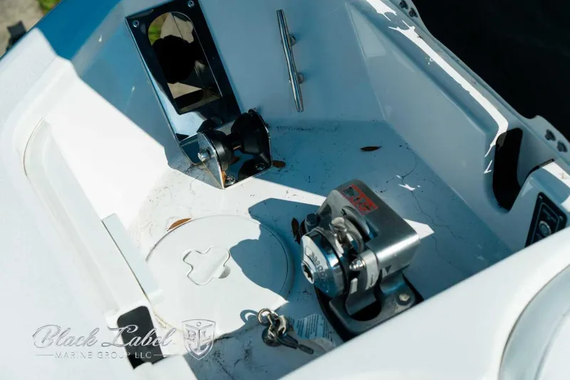 Slide: The Image of 2025 Sea Fox 248 Commander boat anchor compartment with winch and keys. - 10