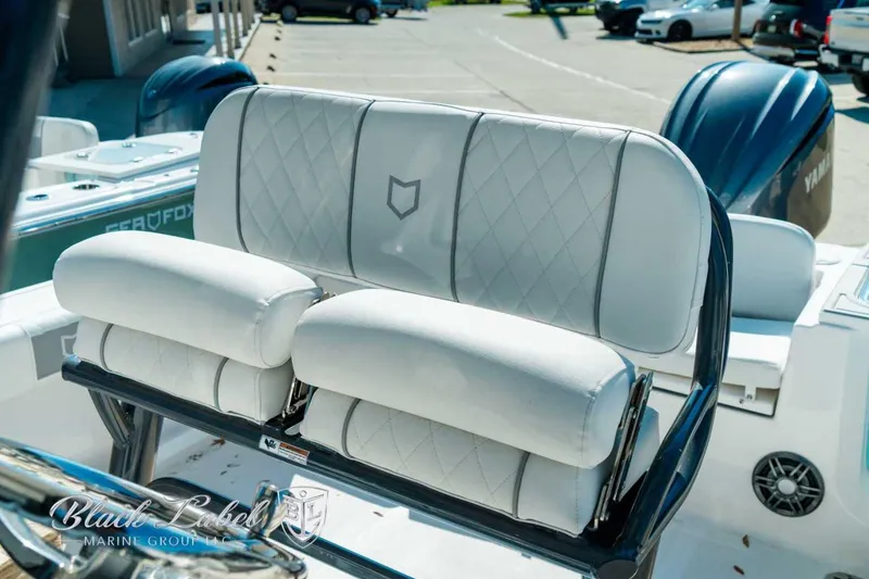 Slide: The Image of 2025 Sea Fox 248 Commander boat seating with white cushioned upholstery and diamond stitching. - 13
