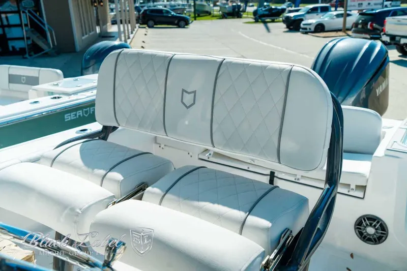 Slide: The Image of 2025 Sea Fox 248 Commander boat interior with cushioned seating and Yamaha engine. - 14