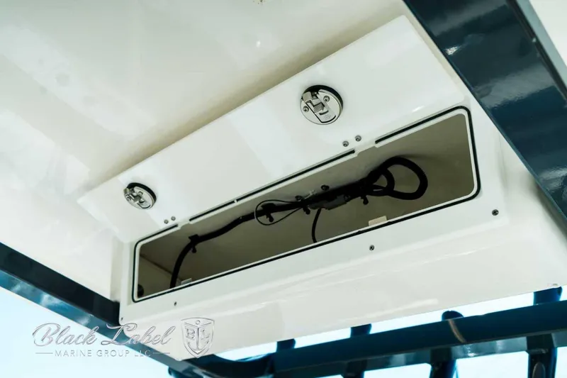 Slide: The Image of 2025 Sea Fox 248 Commander storage compartment with secure latches, showcased by Black Label Marine Group. - 23