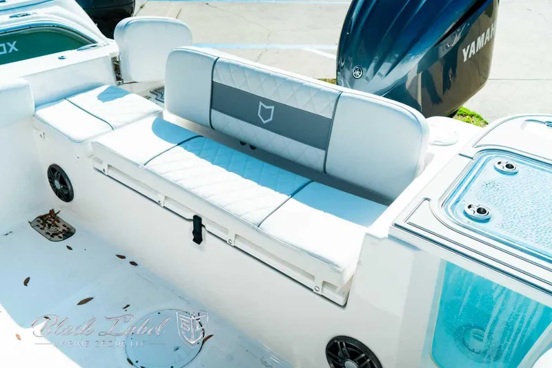 Slide: The Image of 2025 Sea Fox 248 Commander boat interior with cushioned seating and Yamaha engine. - 24
