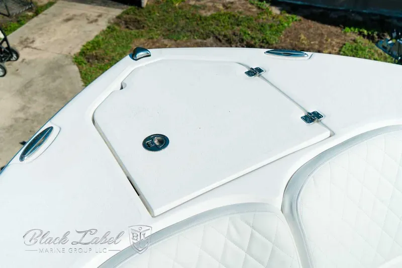 Slide: The Image of 2025 Sea Fox 248 Commander boat deck with storage compartment and quilted seating. - 9