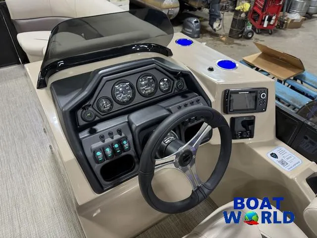 Slide: The Image of 2025 Bentley Pontoons Legacy 223 Tritoon dashboard with steering wheel and control panel. - 13