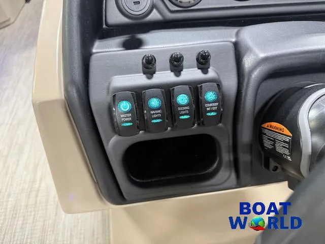 Slide: The Image of Control panel of 2025 Bentley Pontoons Legacy 223 Swingback Tritoon, featuring various switches. - 14