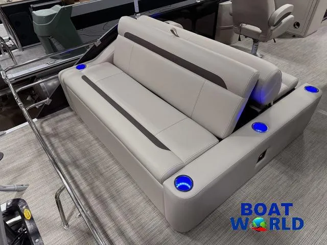 Slide: The Image of 2025 Bentley Pontoons Legacy 223 Tritoon interior with plush seating and illuminated cup holders. - 19