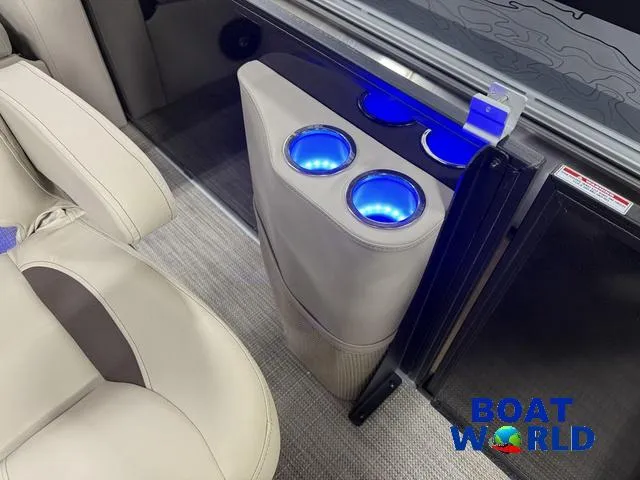 Slide: The Image of 2025 Bentley Pontoons Legacy 223 Tritoon interior with illuminated cup holders and luxury seating. - 27