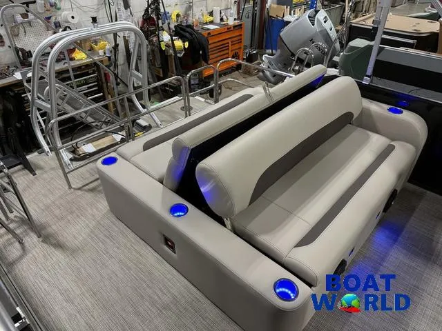 Slide: The Image of 2025 Bentley Pontoons Legacy 223 Swingback Tritoon interior with plush seating and blue LED cup holders. - 28