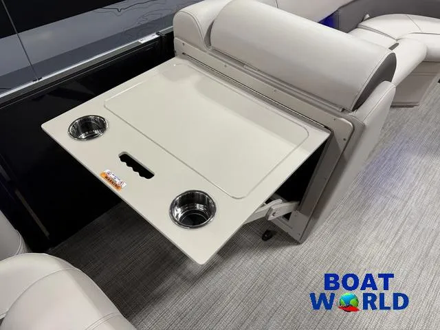 Slide: The Image of 2025 Bentley Pontoons Legacy 223 Swingback Tritoon interior with fold-out table and cup holders. - 30