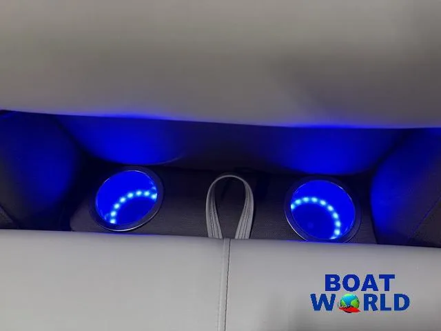 Slide: The Image of 2025 Bentley Pontoons Legacy 223 interior with illuminated cup holders, blue LED lighting. - 32