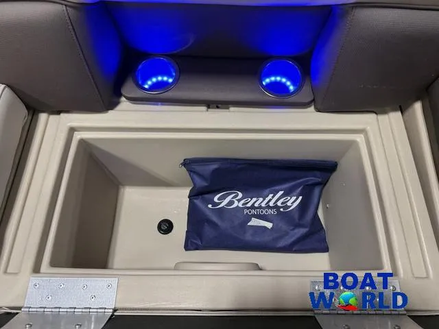 Slide: The Image of 2025 Bentley Pontoons Legacy 223 Tritoon storage compartment with blue LED cup holders. - 33