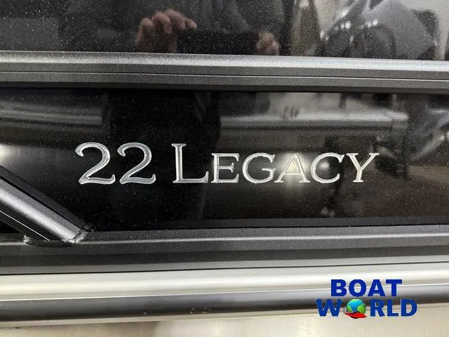 Slide: The Image of 2025 Bentley Pontoons Legacy 223 Swingback Tritoon logo with Boat World branding. - 42