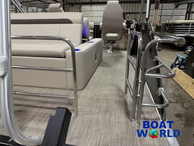 Slide: The Image of 2025 Bentley Pontoons Legacy 223 Swingback Tritoon interior with seating and railing, Boat World logo. - 49