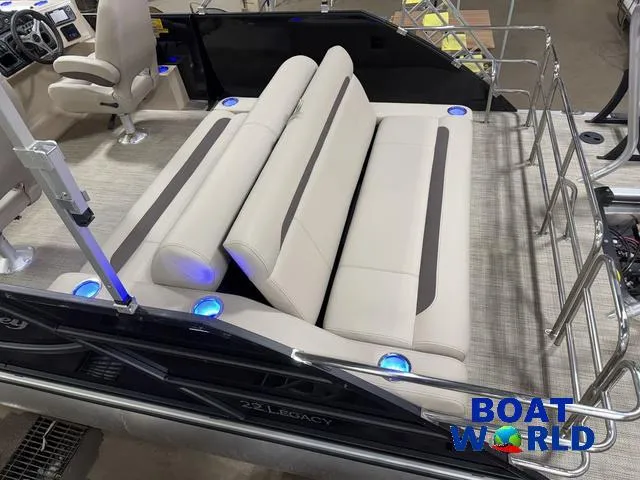 Slide: The Image of 2025 Bentley Pontoons Legacy 223 Swingback Tritoon interior with plush seating and ambient lighting. - 5