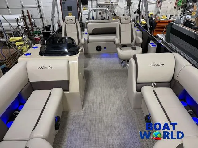 Slide: The Image of 2025 Bentley Pontoons Legacy 223 Swingback Tritoon interior with luxurious seating and ambient lighting. - 7
