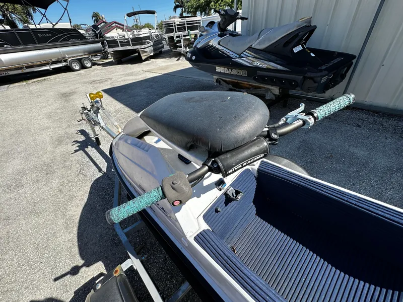 Slide: The Image of 1991 Yamaha WaveRunner Super Jet on trailer, parked outdoors near other watercraft. - 12