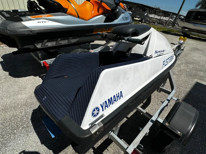 Slide: The Image of 1991 Yamaha WaveRunner Super Jet on trailer, white and black design, outdoor setting. - 6