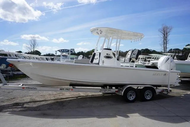 Slide: The Image of 2025 Sea Pro 250 Bay boat on trailer under clear blue sky. - 1