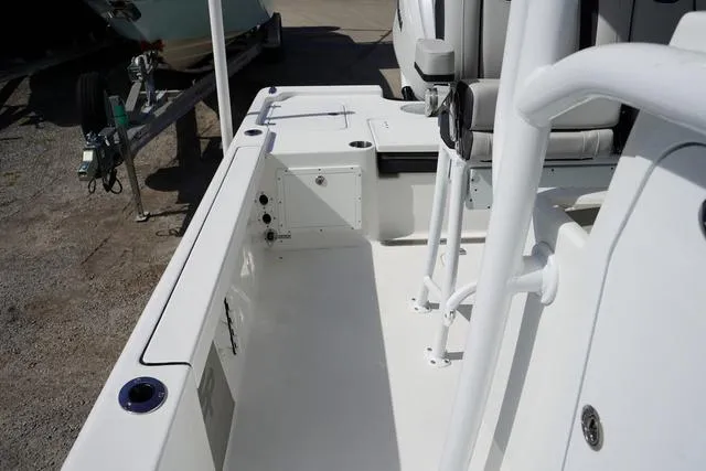 Slide: The Image of 2025 Sea Pro 250 Bay boat interior, showcasing sleek white deck and seating area. - 15