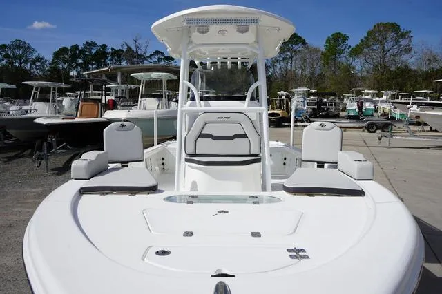 Slide: The Image of 2025 Sea Pro 250 Bay boat with seating, docked outdoors under clear sky. - 3