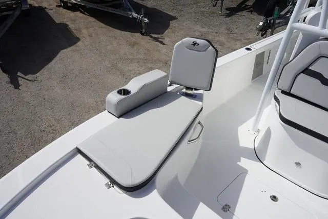 Slide: The Image of 2025 Sea Pro 250 Bay boat interior with cushioned seating and cup holder. - 6