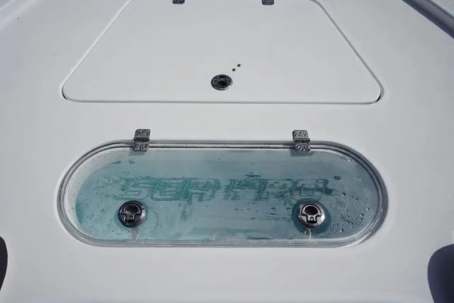 Slide: The Image of 2025 Sea Pro 250 Bay boat deck with logo and storage compartment. - 8