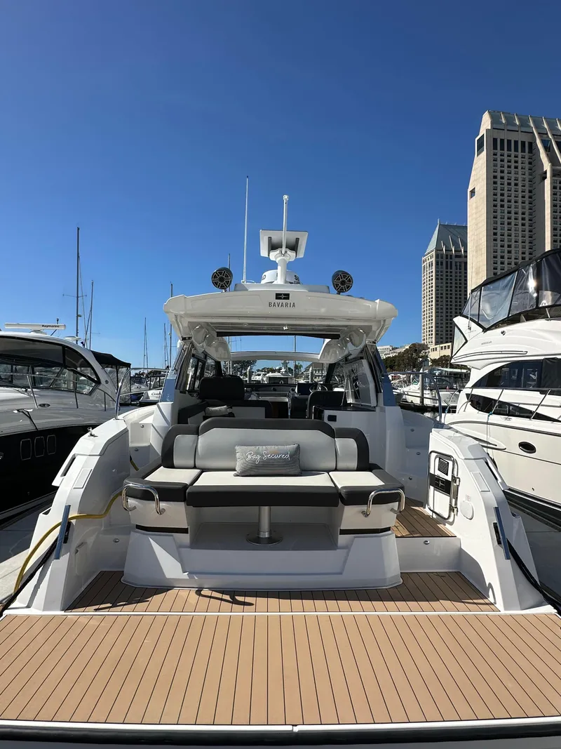 Slide: The Image of 2023 Bavaria SR36 yacht docked in marina, showcasing spacious deck and modern design. - 10