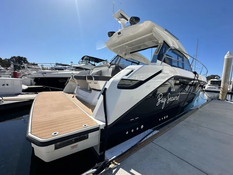Slide: The Image of 2023 Bavaria SR36 yacht docked at marina under clear blue sky. - 11