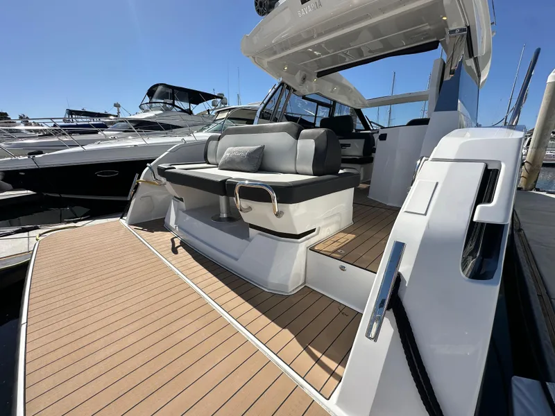 Slide: The Image of 2023 Bavaria SR36 yacht with sleek deck and modern seating at marina. - 13