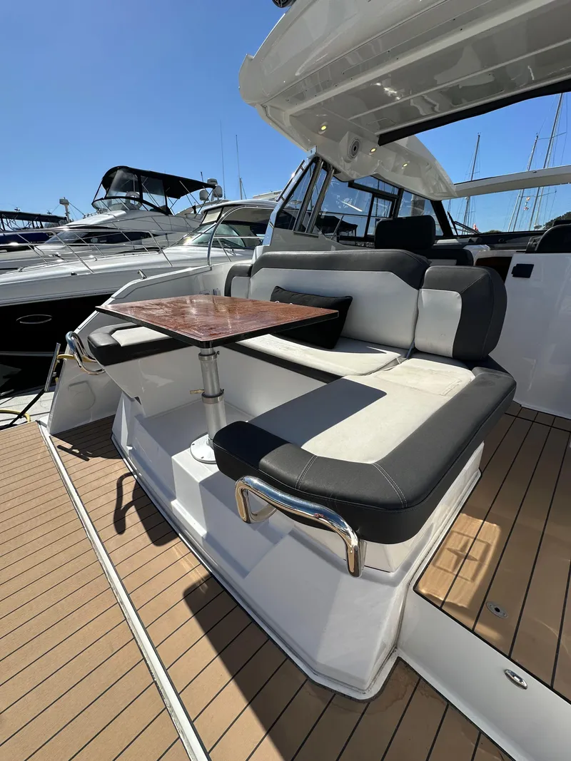 Slide: The Image of 2023 Bavaria SR36 yacht with sleek seating and wooden table on deck. - 17