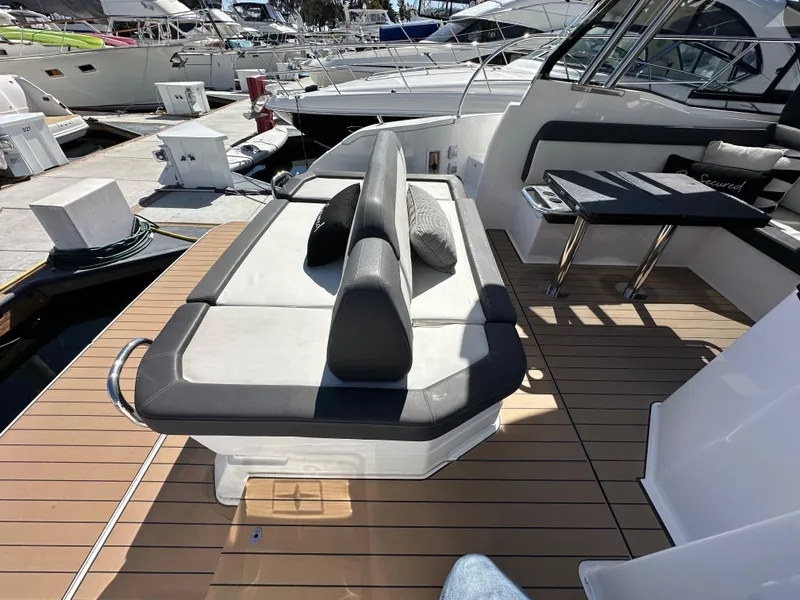 Slide: The Image of 2023 Bavaria SR36 yacht deck with seating and table, docked at marina. - 19