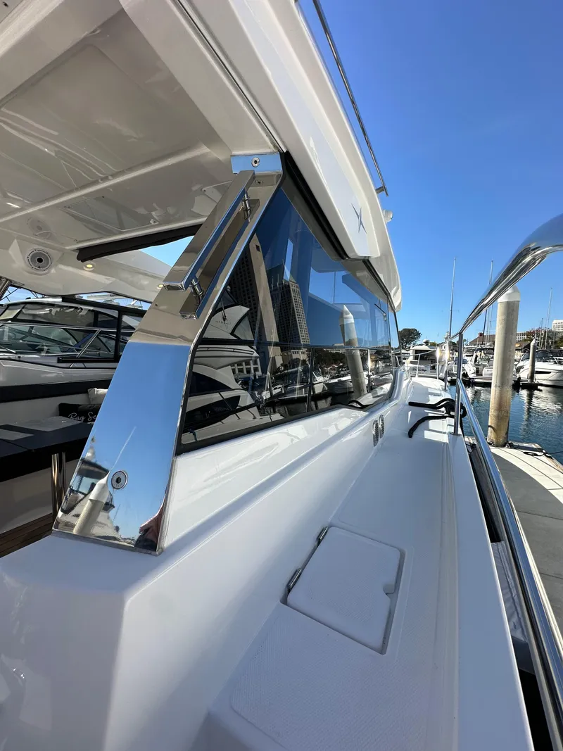 Slide: The Image of 2023 Bavaria SR36 yacht, sleek design, docked at marina under clear blue sky. - 22