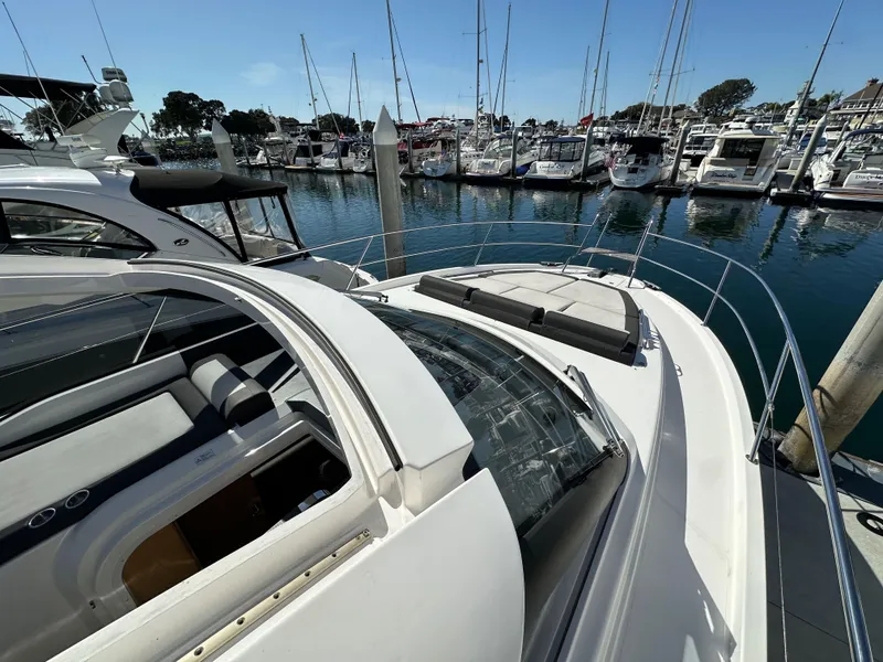Slide: The Image of 2023 Bavaria SR36 yacht docked at a marina, showcasing sleek design and luxury features. - 24