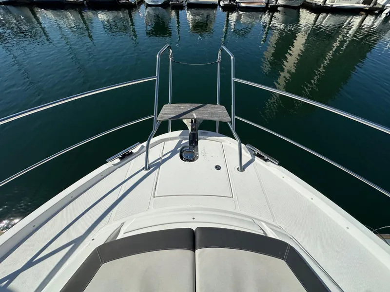 Slide: The Image of 2023 Bavaria SR36 boat bow with railing and water reflection in marina. - 26