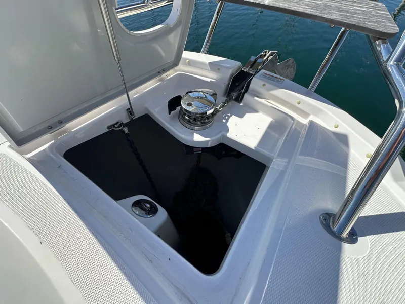 Slide: The Image of 2023 Bavaria SR36 yacht anchor compartment with winch, open hatch, and stainless steel fittings. - 27