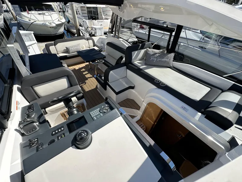 Slide: The Image of 2023 Bavaria SR36 yacht interior with modern seating and control panel. - 31