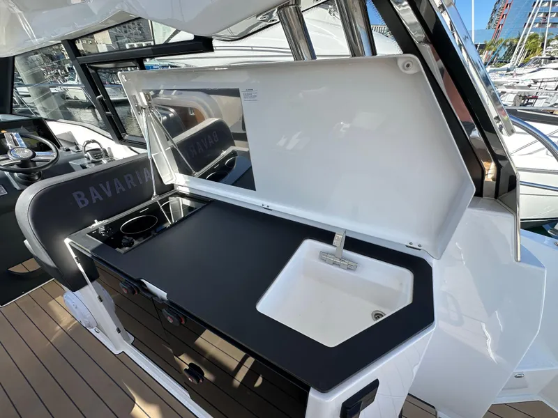 Slide: The Image of 2023 Bavaria SR36 yacht kitchenette with sink and stove, featuring sleek design and modern amenities. - 40
