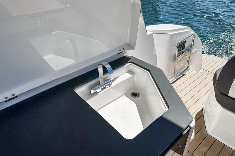 Slide: The Image of 2023 Bavaria SR36 yacht sink with modern design on deck, overlooking water. - 43