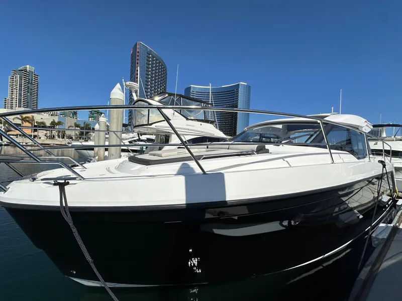 Slide: The Image of 2023 Bavaria SR36 yacht docked in marina with city skyline background. - 7