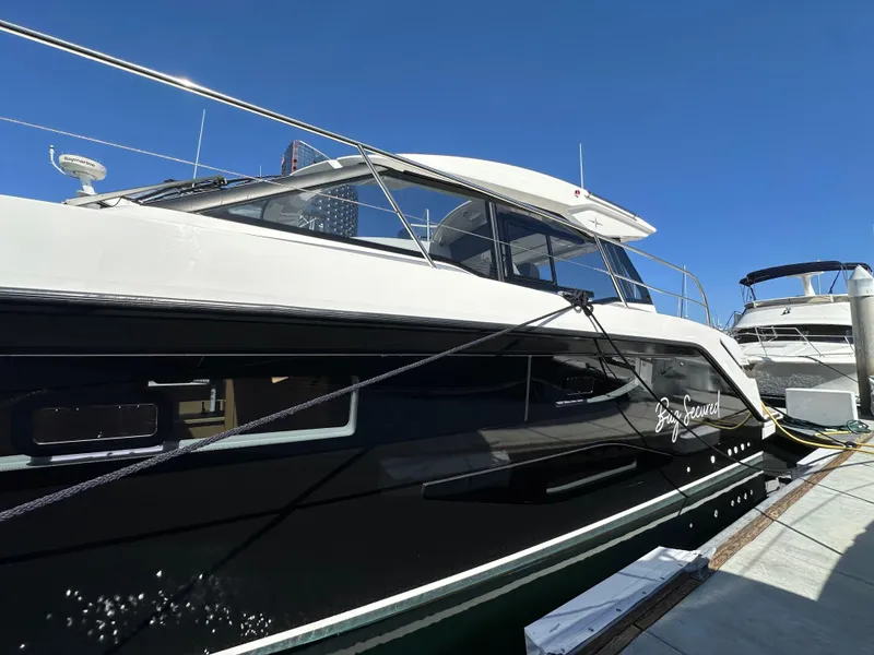 Slide: The Image of 2023 Bavaria SR36 yacht docked under clear blue sky. - 8