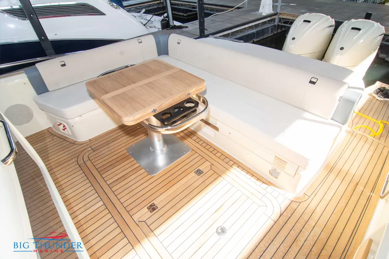 Slide: The Image of 2024 Invictus GT370S yacht interior with elegant seating and wooden table. - 14