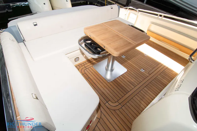 Slide: The Image of 2024 Invictus GT370S yacht deck with wooden table and seating area. - 16